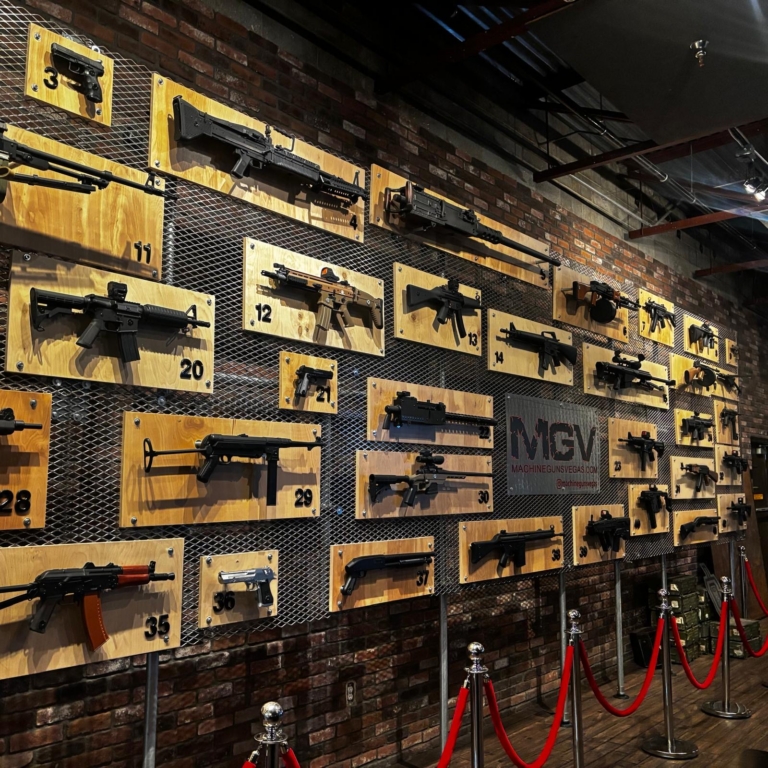 Wall of machine guns and rifles on display at the Machine Guns Vegas indoor range